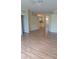 Spacious open floor plan with natural light, ceiling fan, and wood-look flooring at 13231 Cherry Bark Cir, Riverview, FL 33579