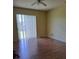 Bright, large living room featuring wood-look floors and a ceiling fan at 13231 Cherry Bark Cir, Riverview, FL 33579