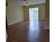 Open living room with sliding glass doors to the backyard and wood-look flooring at 13231 Cherry Bark Cir, Riverview, FL 33579