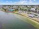 Scenic aerial view of waterfront community with a beach, restaurant, boat docks, and covered picnic pavilions at 13553 Glaze Brook Dr, Hudson, FL 34667