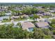 Expansive aerial view of a residential community, with tree-lined streets and varied home styles at 13553 Glaze Brook Dr, Hudson, FL 34667