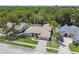 Beautiful aerial view of a home with mature landscaping, a pool, and a paved driveway at 13553 Glaze Brook Dr, Hudson, FL 34667