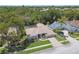Serene aerial view of a property featuring a private home surrounded by mature trees and lush greenery at 13553 Glaze Brook Dr, Hudson, FL 34667