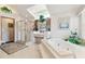 Clean bathroom featuring separate tub, shower, and ample vanity space at 13553 Glaze Brook Dr, Hudson, FL 34667
