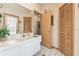 Bathroom with a large vanity, ample storage, and a doorway leading to another room at 13553 Glaze Brook Dr, Hudson, FL 34667