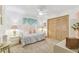 Bright bedroom with a ceiling fan, neutral carpet, and a closet with paneled doors at 13553 Glaze Brook Dr, Hudson, FL 34667