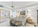 Bright bedroom with floral bedding, and a large window to the outside at 13553 Glaze Brook Dr, Hudson, FL 34667
