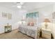 Inviting bedroom with a ceiling fan, natural lighting, and a decorative accent lamps at 13553 Glaze Brook Dr, Hudson, FL 34667