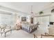 Bright bedroom with light walls, carpet, ceiling fan, with a large window and nice furnishings at 13553 Glaze Brook Dr, Hudson, FL 34667