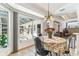 Bright breakfast nook features large windows and views of the screened pool and patio at 13553 Glaze Brook Dr, Hudson, FL 34667
