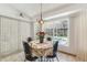 Inviting dining area features a round table, chandelier, and a pool view at 13553 Glaze Brook Dr, Hudson, FL 34667