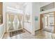 Front entryway has double doors, tile floors, and a view into the bathroom at 13553 Glaze Brook Dr, Hudson, FL 34667
