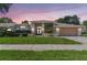 Beautiful single-story home with a well-manicured lawn, mature landscaping, and a two-car garage at 13553 Glaze Brook Dr, Hudson, FL 34667