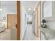 Hallway with tile flooring and decorative shelving leads to bedroom and living areas at 13553 Glaze Brook Dr, Hudson, FL 34667
