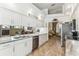 Bright kitchen with stainless appliances, granite countertops, and views into living spaces at 13553 Glaze Brook Dr, Hudson, FL 34667