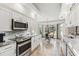 Modern kitchen featuring stainless steel appliances, granite countertops, and a breakfast nook at 13553 Glaze Brook Dr, Hudson, FL 34667