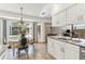 Bright kitchen with granite countertops, stainless appliances, and view to pool area at 13553 Glaze Brook Dr, Hudson, FL 34667