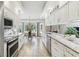Modern kitchen featuring stainless steel appliances, granite countertops, and a breakfast nook at 13553 Glaze Brook Dr, Hudson, FL 34667