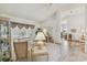 Bright living room features plush seating, neutral tones, and abundant natural light from large windows at 13553 Glaze Brook Dr, Hudson, FL 34667