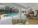 Covered patio view of a refreshing pool and outdoor dining area at 13553 Glaze Brook Dr, Hudson, FL 34667