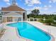 An aerial view of the community pool area featuring clear blue water, privacy fence and surrounding amenities at 13553 Glaze Brook Dr, Hudson, FL 34667
