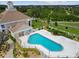 Aerial view of the community pool featuring a fenced-in area, providing a safe and inviting space for relaxation at 13553 Glaze Brook Dr, Hudson, FL 34667