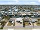 Aerial view of a residential neighborhood with waterfront properties and boat docks on a sunny day at 13810 Malcolm Ave, Hudson, FL 34667