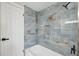 Modern bathroom with blue patterned tiling in shower, white tub, and matte black fixtures gives style at 13810 Malcolm Ave, Hudson, FL 34667