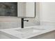 Close-up of a modern bathroom vanity with white marble countertop and matte black faucet fixture at 13810 Malcolm Ave, Hudson, FL 34667