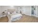 Serene bedroom with plush bedding, gold accents, and ensuite bathroom exudes comfort and relaxation at 13810 Malcolm Ave, Hudson, FL 34667