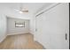 Simple bedroom with wood flooring, large closet, and a ceiling fan offers plenty of room at 13810 Malcolm Ave, Hudson, FL 34667