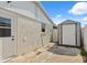 Exterior side view of home with a storage shed and access door at 13810 Malcolm Ave, Hudson, FL 34667