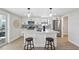 Bright kitchen boasts white cabinets, stainless steel appliances, and marble countertop island with seating at 13810 Malcolm Ave, Hudson, FL 34667