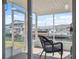 Relaxing screened porch with black wicker chair and waterfront views at 13810 Malcolm Ave, Hudson, FL 34667