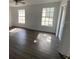 Clean bedroom with wood flooring, two windows, and ample natural light at 13909 Fletchers Mill Dr, Tampa, FL 33613