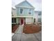 Two-story townhouse featuring a red front door and well-maintained landscaping at 13909 Fletchers Mill Dr, Tampa, FL 33613