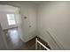 Hallway near the top of the stairs, with a doorway to a bedroom at 13909 Fletchers Mill Dr, Tampa, FL 33613