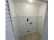 Small laundry room with tile floors and washer dryer hookups at 13909 Fletchers Mill Dr, Tampa, FL 33613