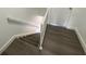 Staircase with wood floors and white railings leading upstairs at 13909 Fletchers Mill Dr, Tampa, FL 33613