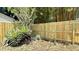 Newly constructed wooden fence provides backyard privacy, complemented by lush greenery at 1419 55Th S St, Gulfport, FL 33707
