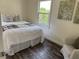 Comfortable bedroom featuring a queen-sized bed, a patterned blanket, and a tranquil vibe at 1419 55Th S St, Gulfport, FL 33707