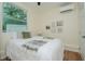 Comfortable bedroom features a cozy bed, neutral decor, and a mini-split to ensure a pleasant climate for restful nights at 1419 55Th S St, Gulfport, FL 33707