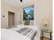 Bright bedroom with a queen bed, large window, and neutral decor at 1419 55Th S St, Gulfport, FL 33707