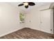 This bedroom features a ceiling fan, wood look floors, and neutral wall color at 1419 55Th S St, Gulfport, FL 33707