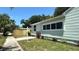 Well-maintained home exterior with fresh landscaping and a 'For Sale' sign at 1419 55Th S St, Gulfport, FL 33707