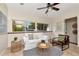 Cozy living room with neutral colors, large windows, and a decorative ceiling fan at 1419 55Th S St, Gulfport, FL 33707