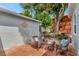 Outdoor patio featuring wicker furniture with blue pillows and brick tile flooring at 1419 55Th S St, Gulfport, FL 33707