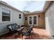 Cozy outdoor patio space with tiled flooring and wicker seating for relaxation and entertainment at 1419 55Th S St, Gulfport, FL 33707