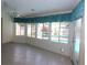 Enclosed Florida room with tile floor, ceiling fan, and views of the backyard pool at 1525 Albemarle Ct, Dunedin, FL 34698