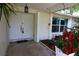 Inviting entryway with double doors, decorative plants, and a welcoming ambiance at 1525 Albemarle Ct, Dunedin, FL 34698